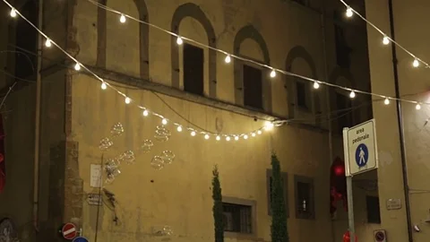Artist makes big soap bubbles at night on the street with lightbulbs on line Stock Footage 78015234