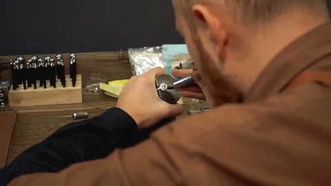 Artist makes grooves in the silver ring for inlaying stones Stock Footage 73527183