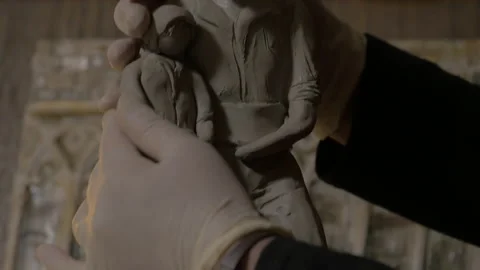Artist models a statue with clay Stock Footage 153934827