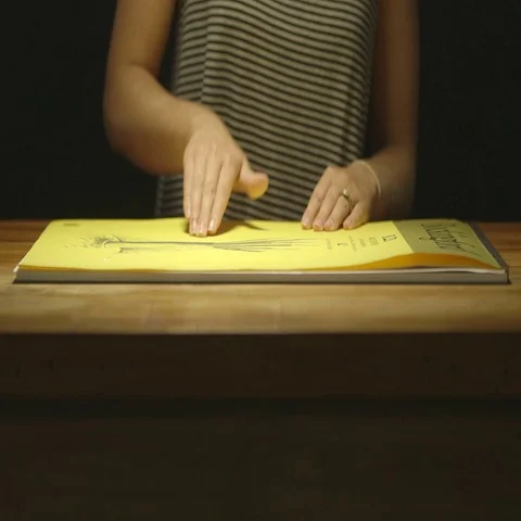 Artist opening drawing pad Stock Footage 69303445