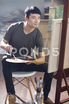 Artist Painting In His Studio