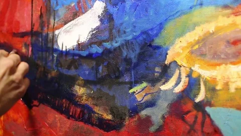 The artist paints a painting on canvas with a brush and oil paints. The process  Stock Footage
