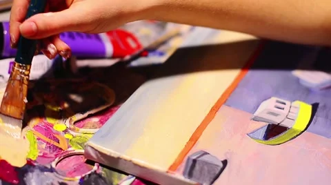 Artist paints a picture of oil paint brush in hand with palette closeup. Stock Footage 59086465