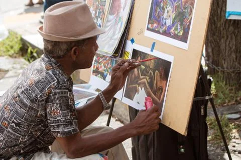 Artist Paints Scene On Paper At Eclectic Arts Festival Stock Photos