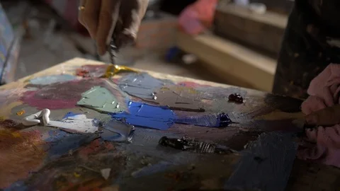 Artist palette knife mix color oil painting on palette is holding in his hand Stock Footage 96384825