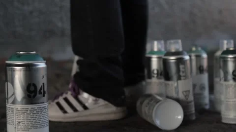 Artist picking up cans Stock Footage 259851205