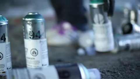 Artist picking up cans Stock Footage 259851214