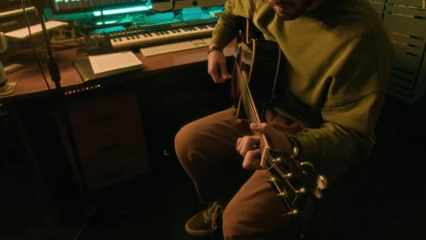 Artist Playing Guitar and Recording Sound on Computer in Studio Stock Footage 303103653