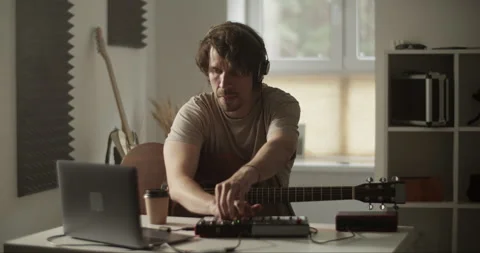 Artist playing guitar and setting mixer Stock Footage 252124368