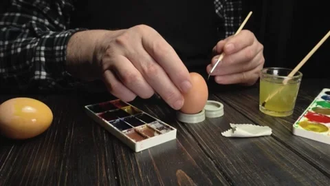 Artist prepares to paint an egg Stock Footage 338035076