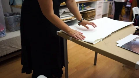 Artist in the process of preparing paper for drawing in watercolor and chalk. Stock Footage 124229181