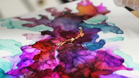 The artist put gold foil using thin brush on the picture. Contemporary art. Stock Footage 129043550