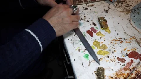Artist restorer working on restoring the old Persian knife Stock Footage 82625768