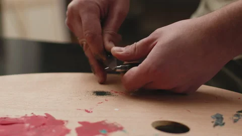 Artist routine. Painter hands sharpening a pencil graphite with cutter knife on Stock Footage 187221022