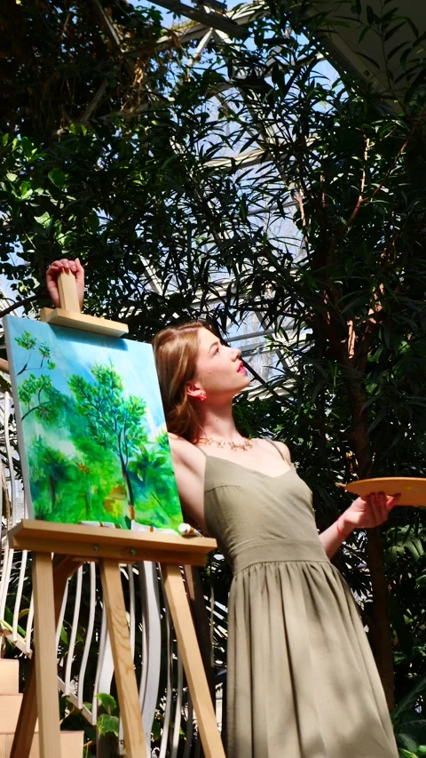 An artist is in a serene studio creating captivating artwork inspired by the Stock Footage 311908177
