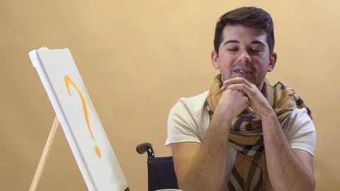 An artist sitting at a table waiting for the muse to paint a picture Stock Footage 124898873