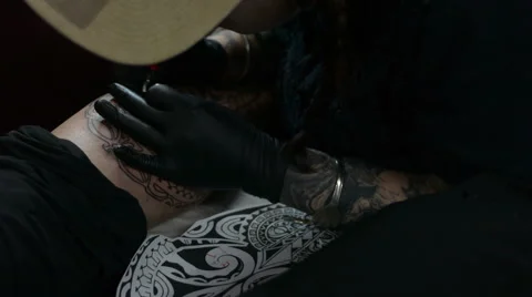 Artist tattooing using reference drawing Stock Footage 47469612