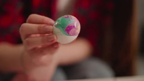 Artist turns vibrant Easter egg with marbling patterns Stock Footage 172542128