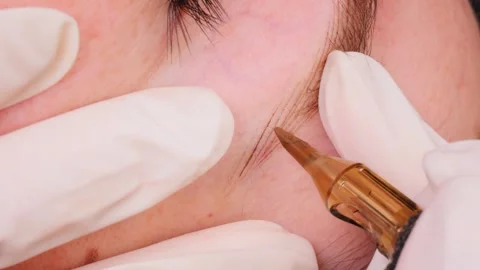 Artist uses microblading tool to expertly draw natural lines Stock Footage 278714524