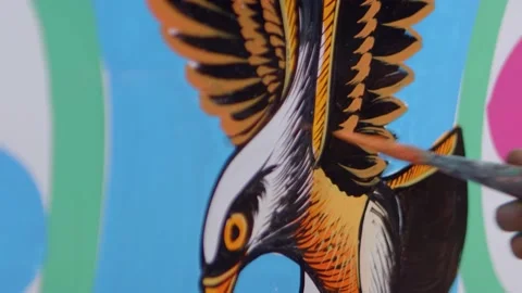 Artist using brush to paint eagle in golden colours Stock Footage 164192782