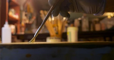 Artist using a fan brush while painting on a wood panel - close up Stock Footage 120638527