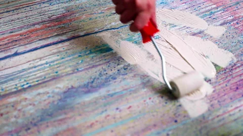 Artist using roller brush and white paint for coating canvas painted surface Stock-Footage 268704285