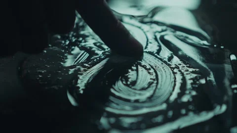 Artistic and Creative Finger Movements in Liquid Surface for Visual Exploration Stock Footage 309474064