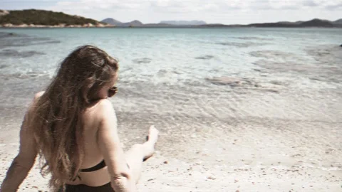 Artistic animated rendering postcard of young attractive woman lying on  beach Stock Footage 108937038