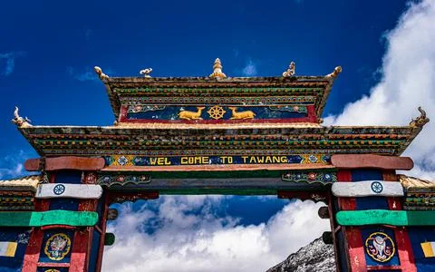 Artistic buddhist decorated entry gate of city with bright blue sky at mornin Фото