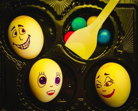 Artistic close-up composition of funny egg family underyellow light feeling f Stock Photos
