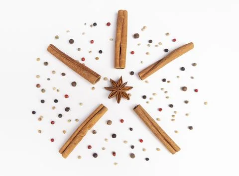 An artistic composition of culinary spices set against a white background Stock Photos