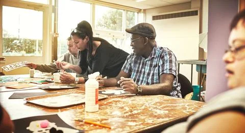 Artistic, creative people with learning disabilities in class at a community Stock Photos