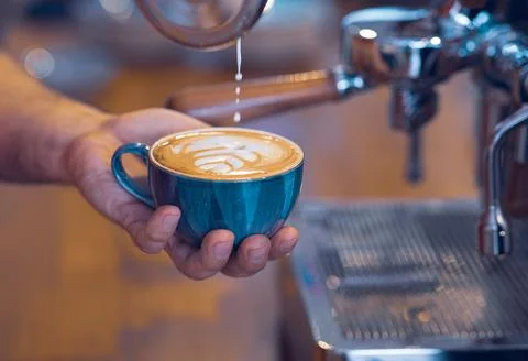 Artistic designed coffee latte view  with coffee beans from a barista desk. Photos
