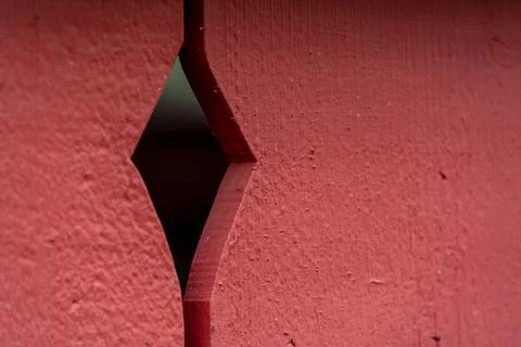 Artistic diamond shape designed into a red fence Stock Photos