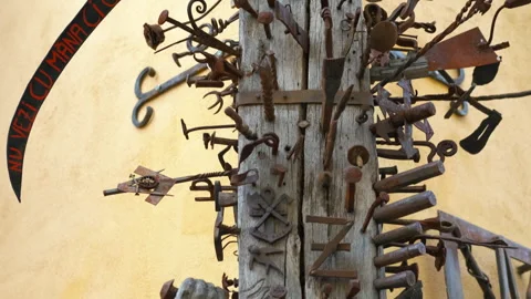 Artistic display of rusty tools on weathered wooden pole Stock Footage 309506934