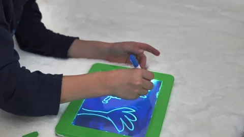 Artistic drawing of a boy on a digital tablet computer at home Stock Footage 149205500