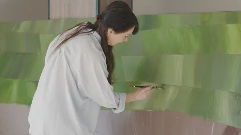 Artistic expression through painting in a bright studio filled Stock Footage 322060012