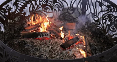 Artistic fire pit with flames on a winter evening scene 스톡 동영상 296951482