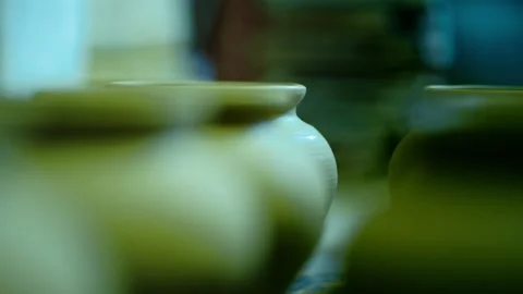Artistic focus transition between rows of raw clay vessels in a workshop. Stock Footage 328925565