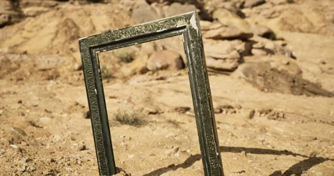 Artistic frame standing alone in a desert landscape under bright sunlight Stock Footage 317513291