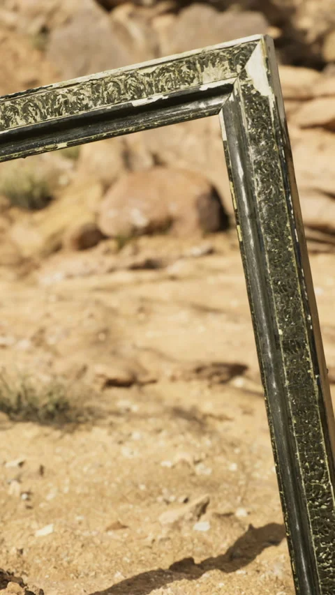 Artistic frame standing alone in a desert landscape under bright sunlight Stock Footage 327384071