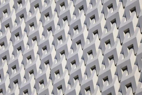 Artistic grey white 3D pattern of modern building facade in the sunlight Ilustración de archivo