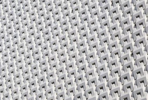 Artistic grey white 3D pattern of modern building facade in the sunlight Fotos de archivo