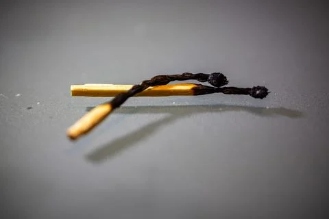 Artistic macro image of two burned matchsticks Stock Photos
