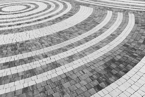 Artistic pattern of concentric white circular lines, decorative stone pavemen Stock Photos