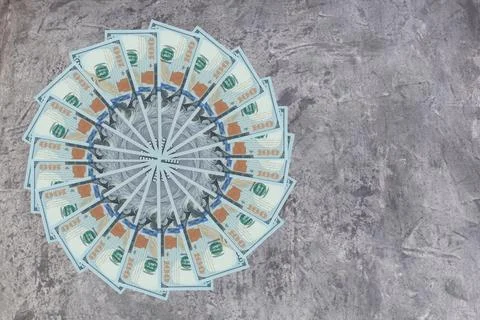 Artistic pattern made from dollar bills Snowflake, flower or star on wooden.. Foto stock