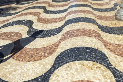 An artistic pattern of wavy cobblestones creates a visually engaging surface Stock Photos