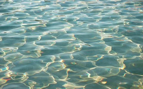 Artistic patterns of water surface in the pool reflecting with the sunlight Stock Photos