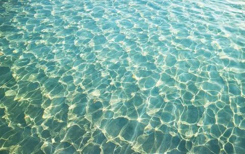 Artistic patterns of water surface in the pool reflecting with sunlight Stock Photos