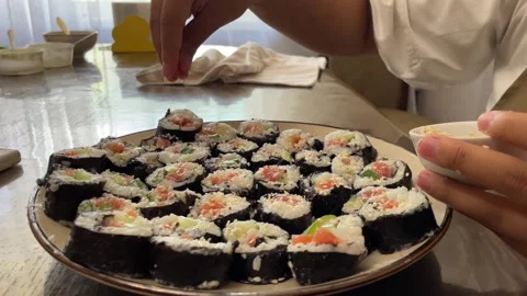 Artistic process of finishing sushi rolls, showcasing the beauty and attention 動画素材 280985161